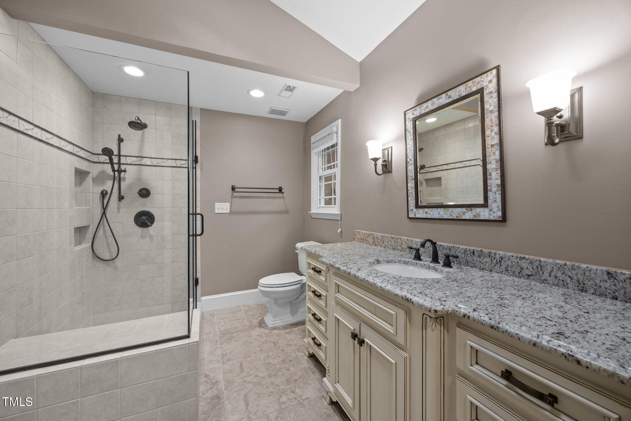 2204 Corberrie Lane Raleigh, NC 27613 - Photo 24 of 39 a bathroom with a granite countertop sink a mirror a toilet and shower
