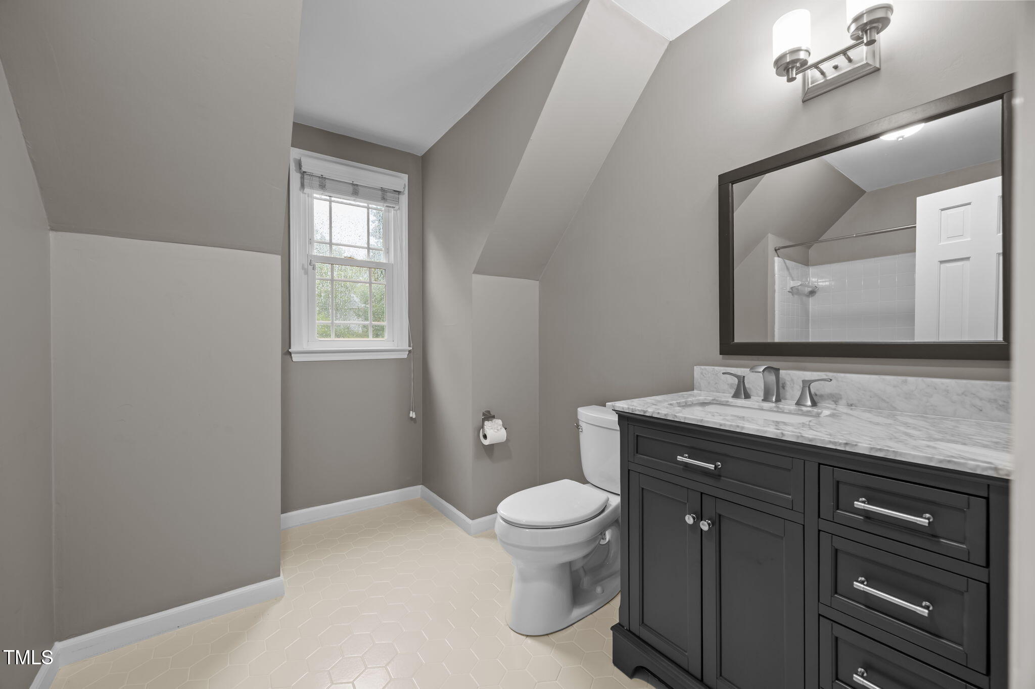 2204 Corberrie Lane Raleigh, NC 27613 - Photo 27 of 39 a spacious bathroom with a granite countertop toilet a sink a mirror and a window