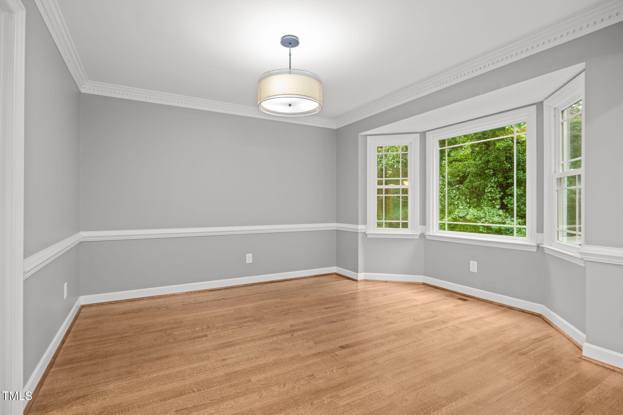 2204 Corberrie Lane Raleigh, NC 27613 - Photo 8 of 39 a view of an empty room with wooden floor and a window