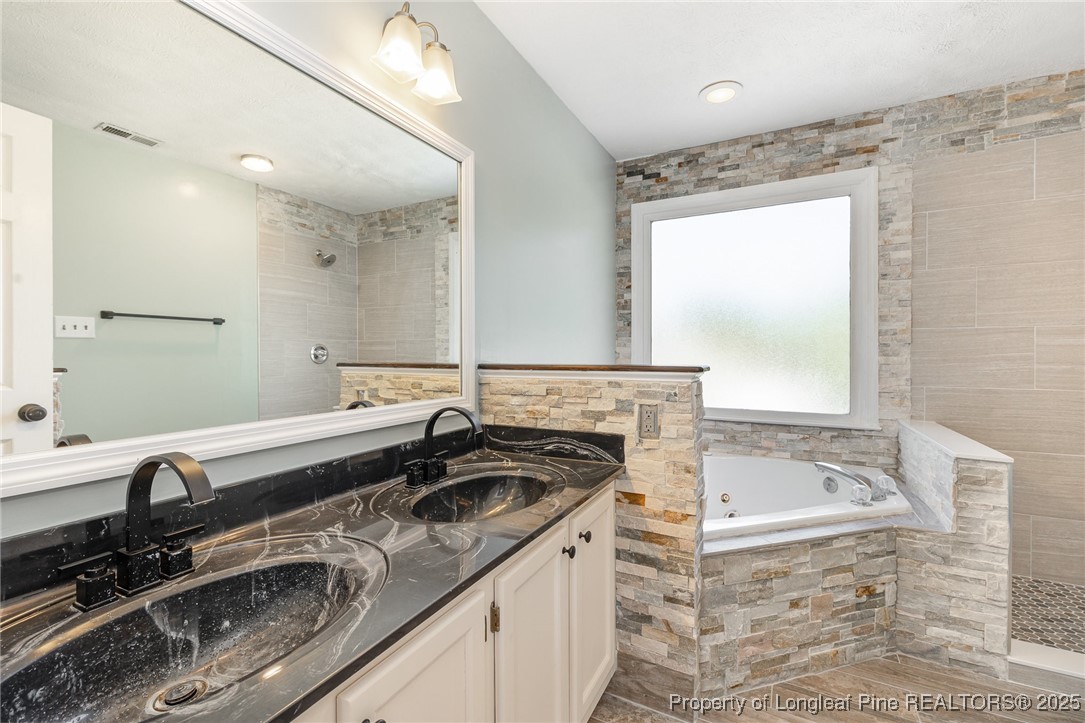 7810 Shuttle Road Fayetteville, NC 28311 - Photo 12 of 25 a bathroom with a granite countertop sink and a bathtub