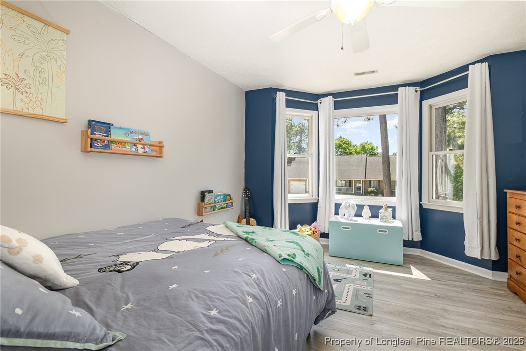 7810 Shuttle Road Fayetteville, NC 28311 - Photo 14 of 25 a bedroom with a large bed and a large window