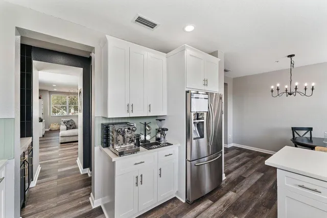 a kitchen with a refrigerator and cabinets