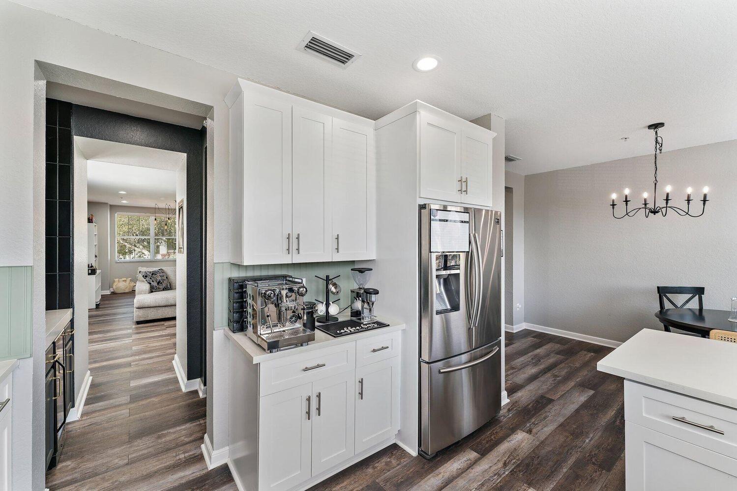 500 Pacific Grove Drive, Unit 8 West Palm Beach, FL 33401 - Photo 11 of 35 a kitchen with a refrigerator and cabinets