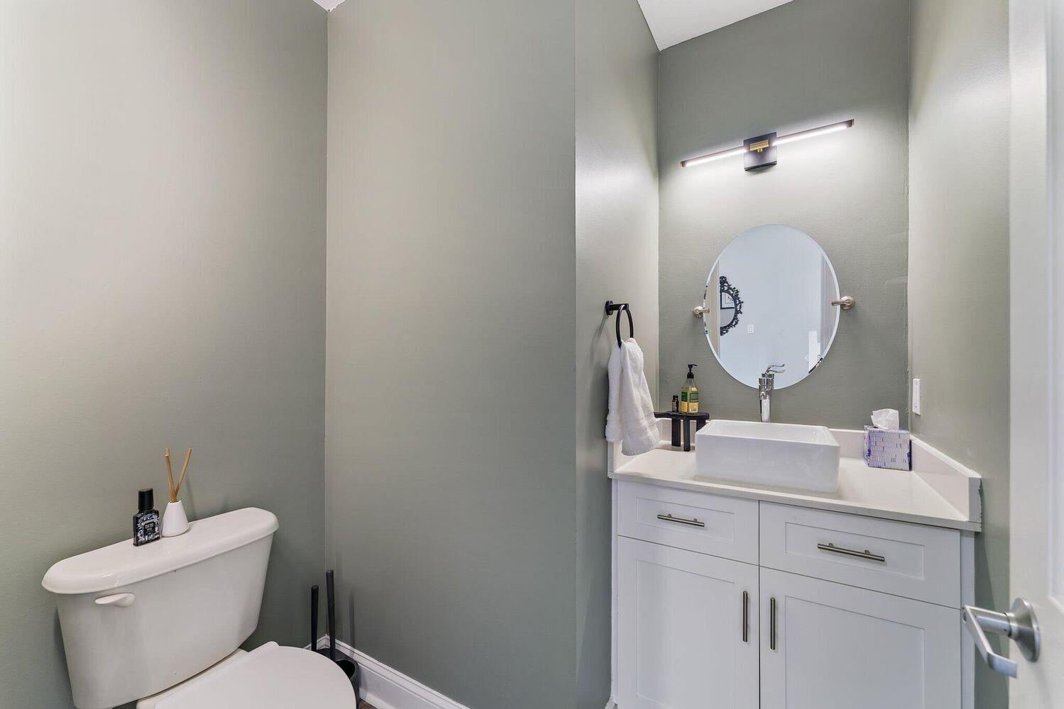500 Pacific Grove Drive, Unit 8 West Palm Beach, FL 33401 - Photo 13 of 35 a bathroom with a toilet sink mirror and vanity