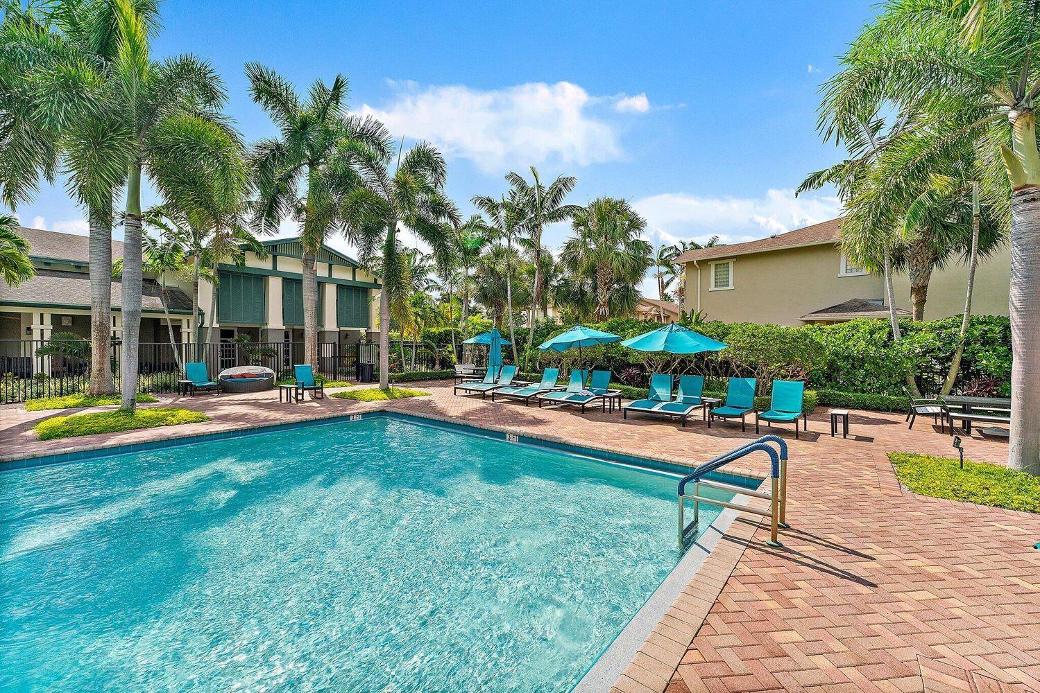 500 Pacific Grove Drive, Unit 8 West Palm Beach, FL 33401 - Photo 22 of 35 a view of swimming pool with lawn chairs and plants