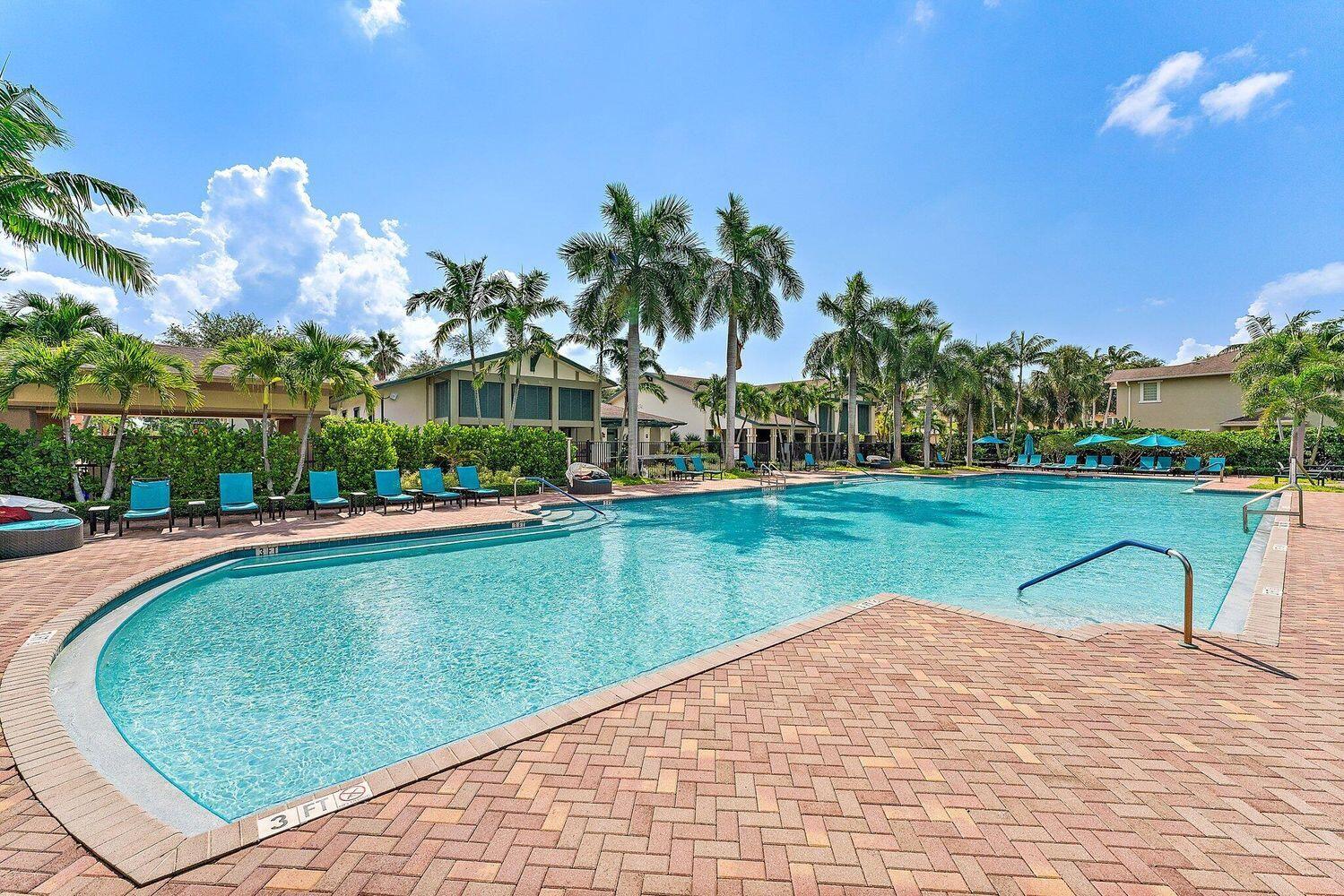 500 Pacific Grove Drive, Unit 8 West Palm Beach, FL 33401 - Photo 23 of 35 a view of a swimming pool and a yard
