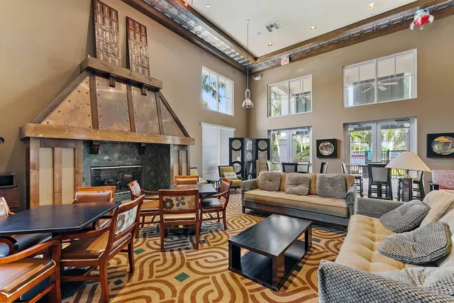a living room with furniture a fireplace and a large window
