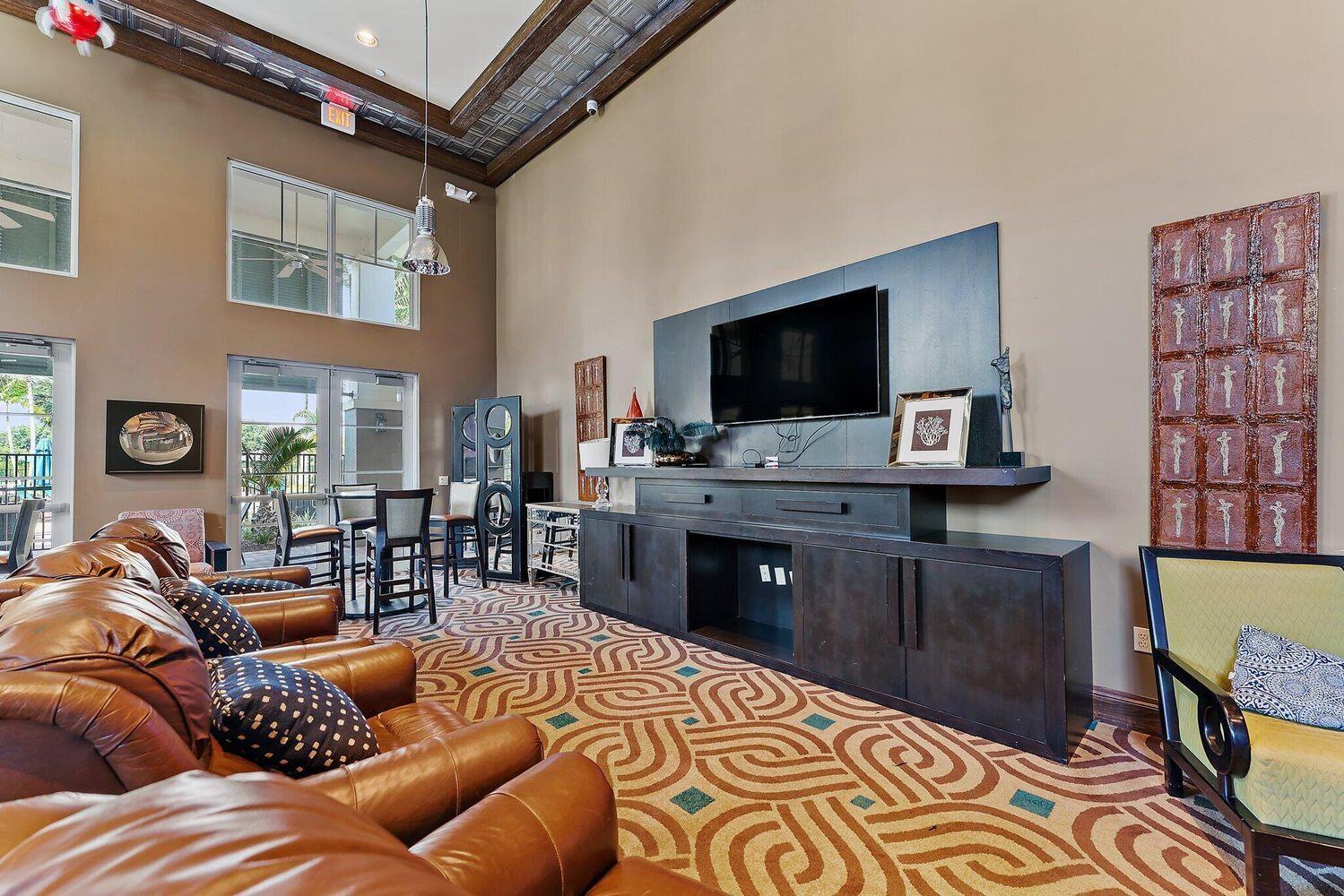 500 Pacific Grove Drive, Unit 8 West Palm Beach, FL 33401 - Photo 30 of 35 a living room with furniture and a flat screen tv
