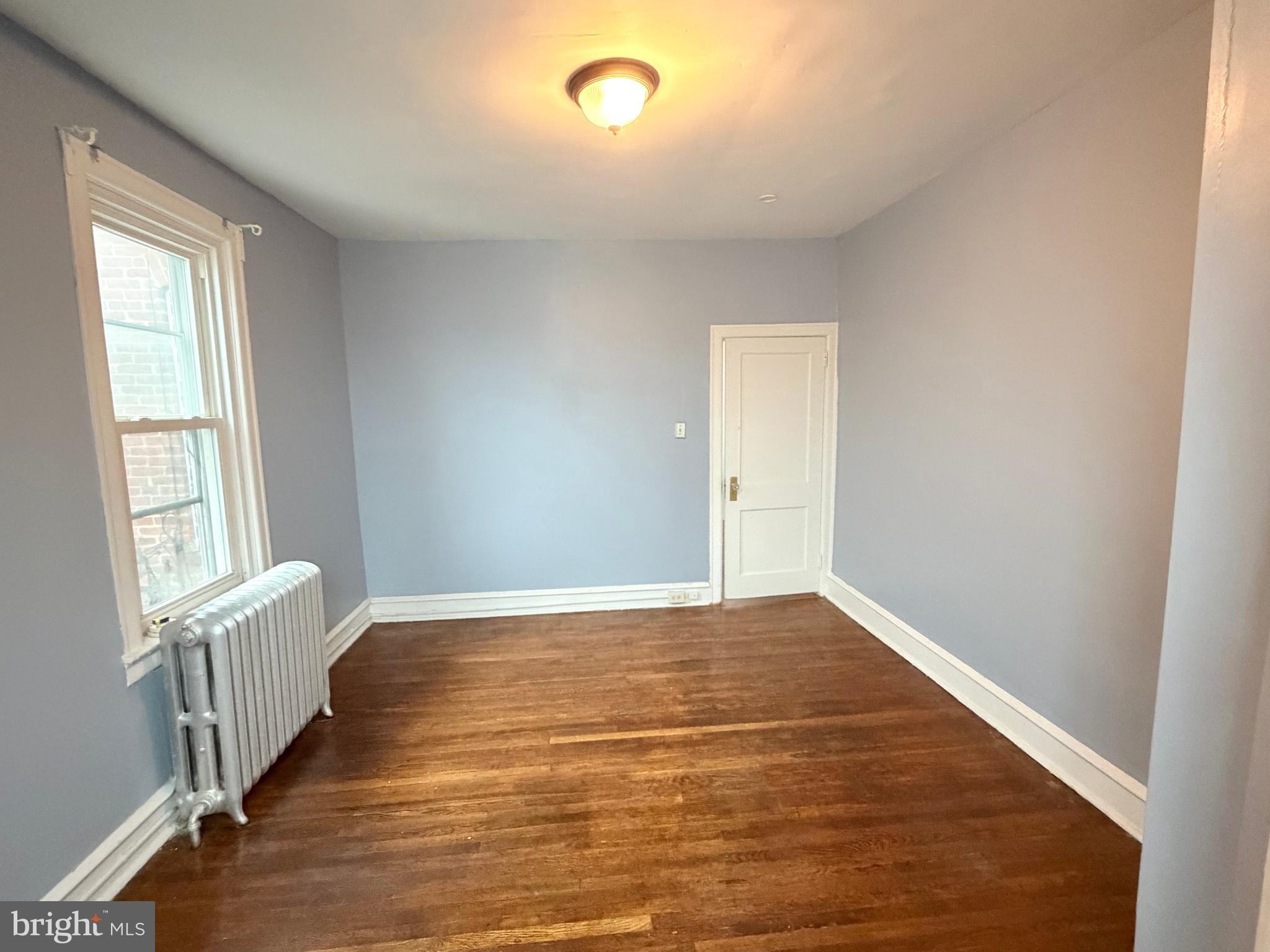 51 North State Road Upper Darby, PA 19082 - Photo 10 of 12 a view of an empty room with wooden floor and a window