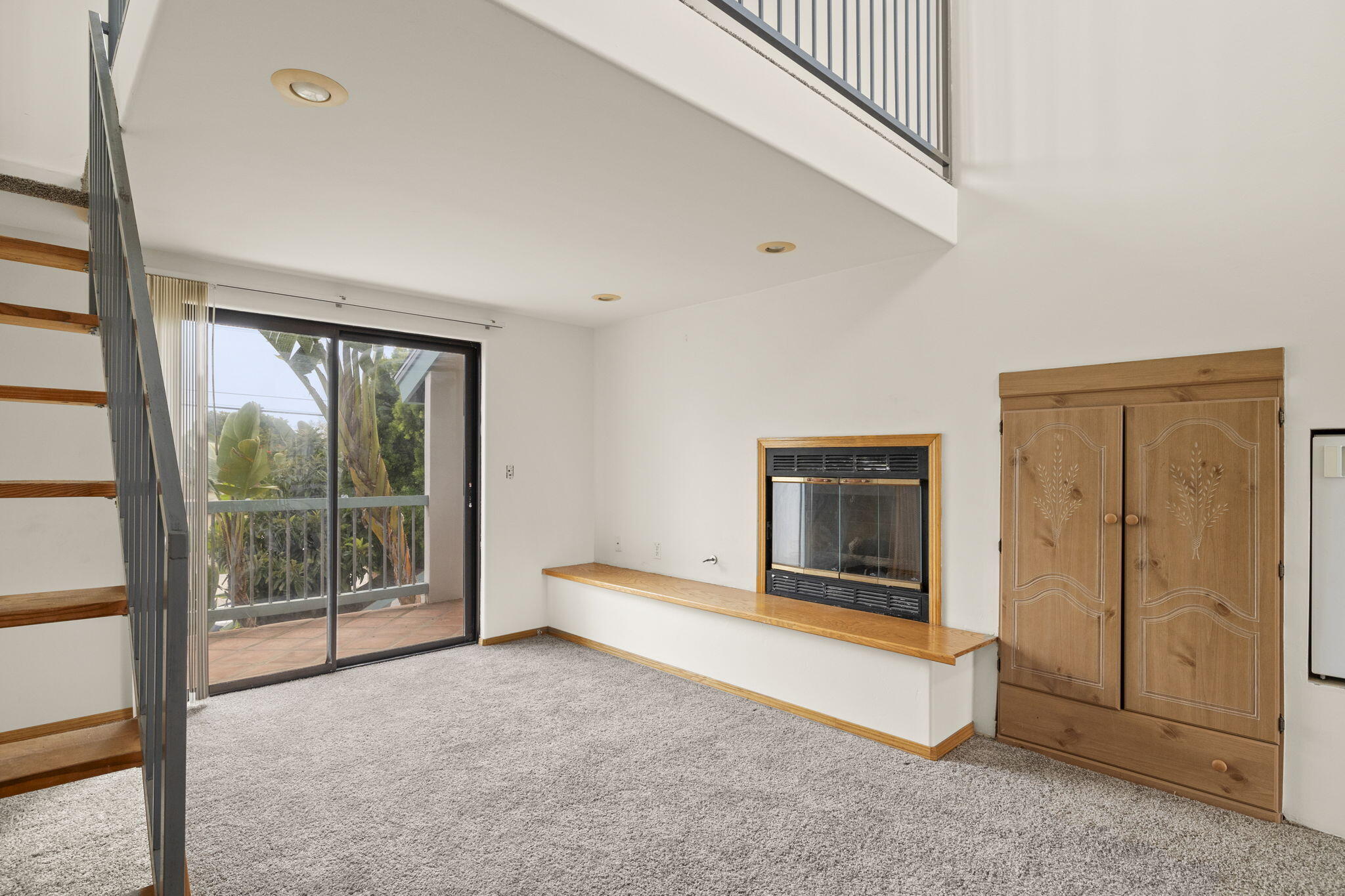 6870 Trigo Road Goleta, CA 93117 - Photo 11 of 25 an empty room with sliding door and wooden floor