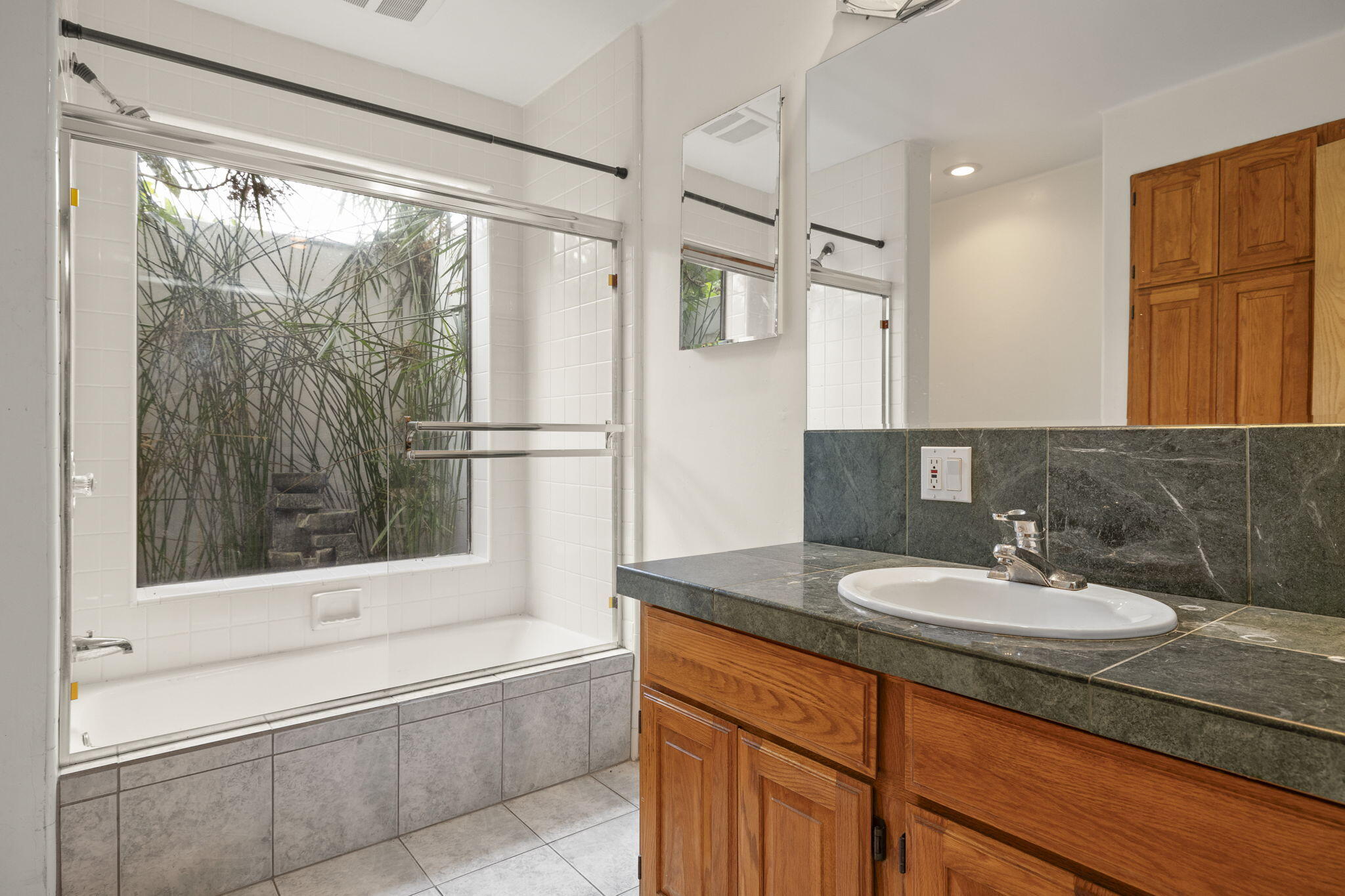 6870 Trigo Road Goleta, CA 93117 - Photo 12 of 25 a bathroom with a sink and a mirror