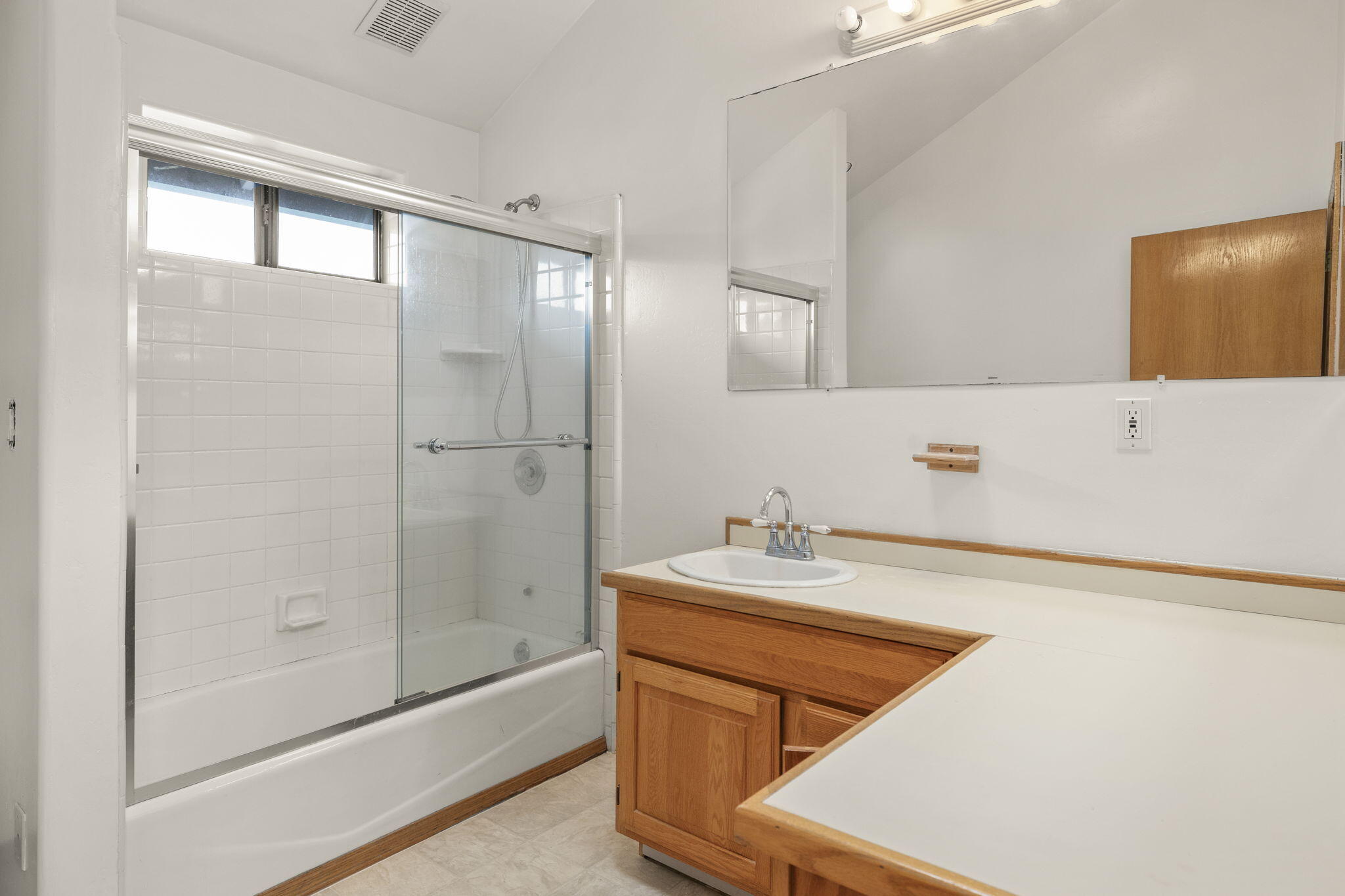 6870 Trigo Road Goleta, CA 93117 - Photo 17 of 25 a bathroom with a sink a toilet and shower