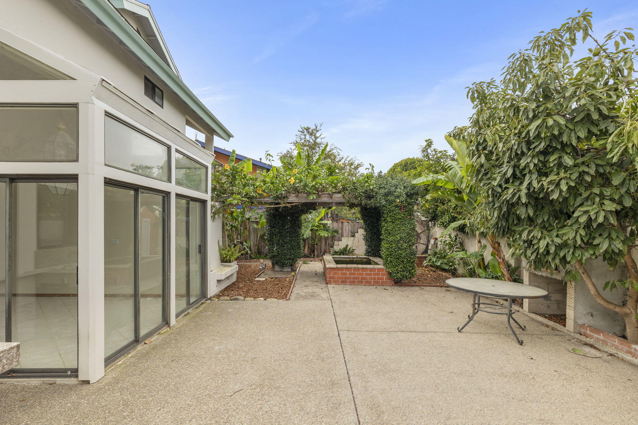 6870 Trigo Road Goleta, CA 93117 - Photo 18 of 25 a backyard of a house with outdoor seating