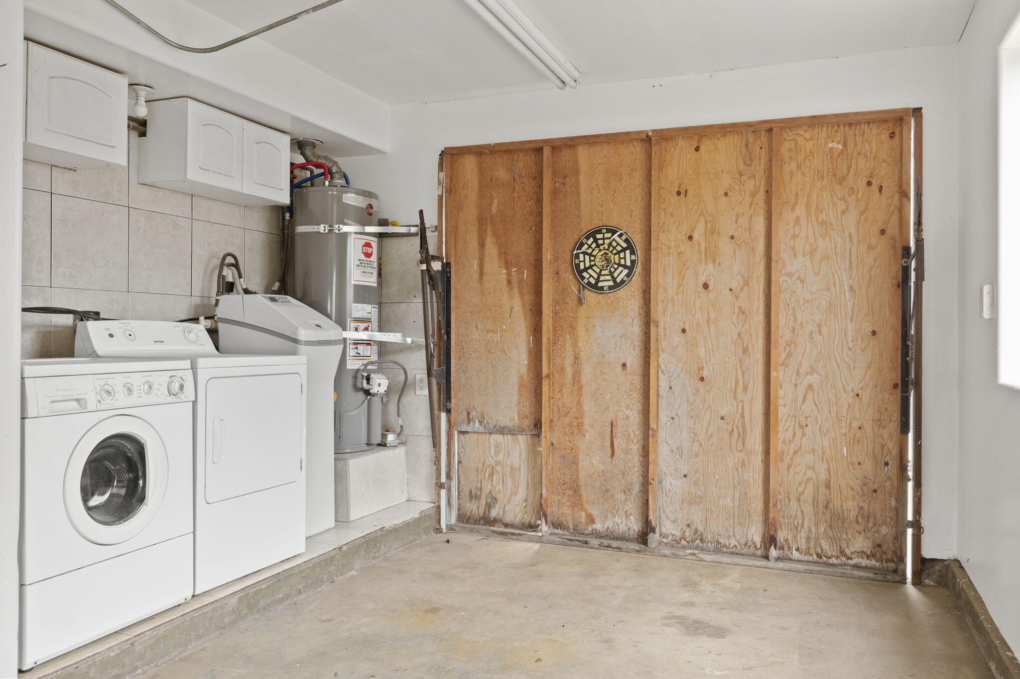 6870 Trigo Road Goleta, CA 93117 - Photo 21 of 25 a view of a storage & utility room with dryer and washer
