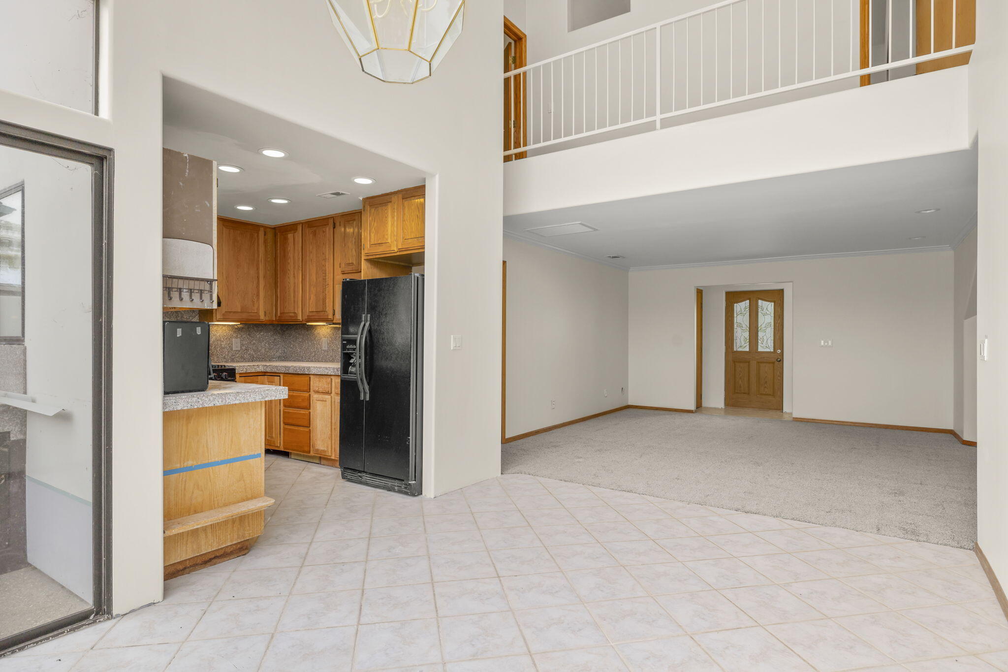 6870 Trigo Road Goleta, CA 93117 - Photo 5 of 25 a view of a kitchen with a sink and dishwasher a refrigerator with white cabinets