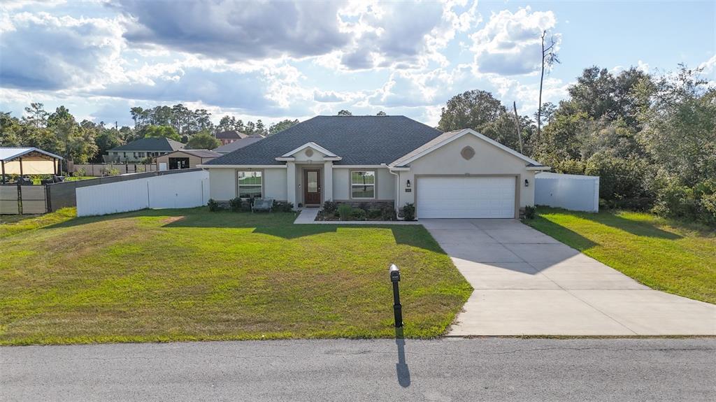 10396 Southwest 45th Avenue Ocala, FL 34476 - Photo 1 of 18 a view of a house with a big yard plants and large trees