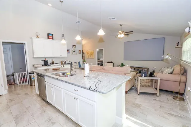 a bathroom with a granite countertop sink a toilet and a mirror