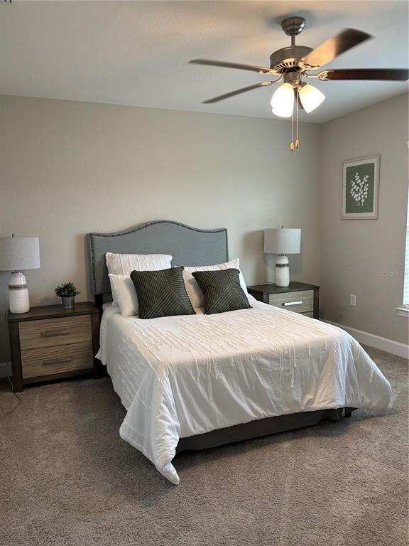 10396 Southwest 45th Avenue Ocala, FL 34476 - Photo 14 of 18 a bedroom with a bed and a chandelier
