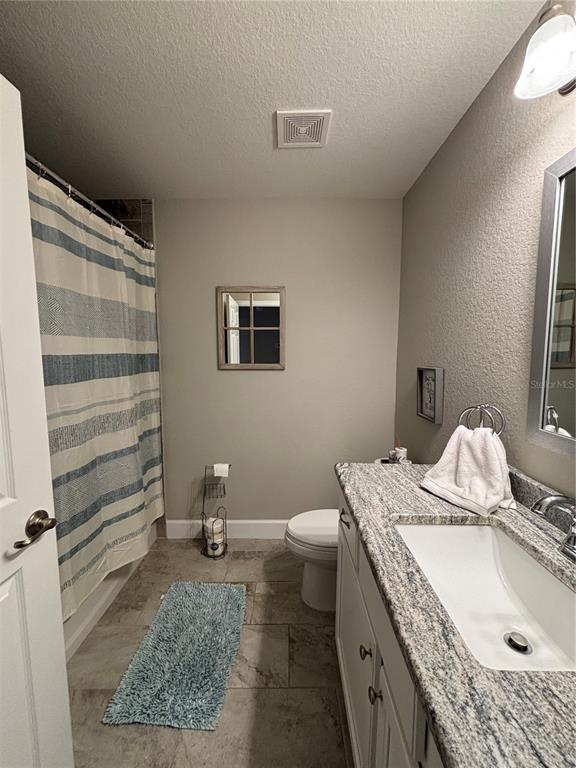 10396 Southwest 45th Avenue Ocala, FL 34476 - Photo 18 of 18 a bathroom with a granite countertop sink and a mirror