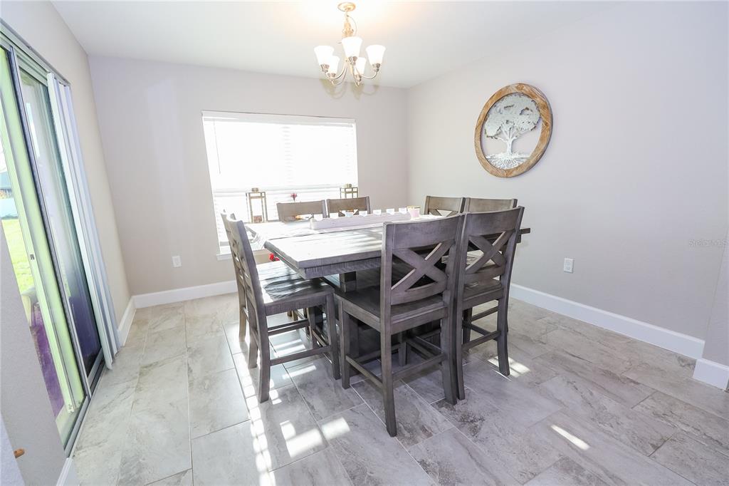 10396 Southwest 45th Avenue Ocala, FL 34476 - Photo 6 of 18 a view of a dining area with furniture window and wooden floor