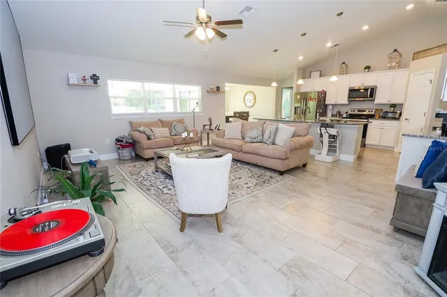 a living room with furniture and kitchen view