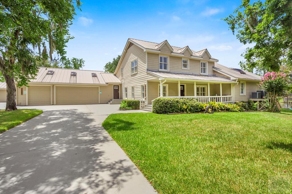 14009 West Hughes Road Dickinson, TX 77539 - Photo 1 of 54 a front view of a house with a garden and yard