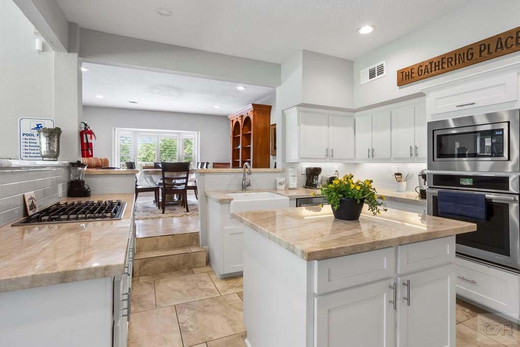 14009 West Hughes Road Dickinson, TX 77539 - Photo 11 of 54 a kitchen with a sink refrigerator and cabinets