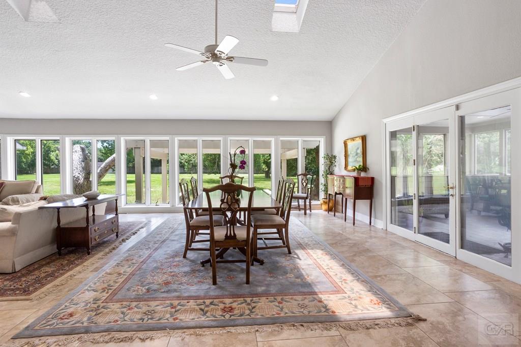 14009 West Hughes Road Dickinson, TX 77539 - Photo 13 of 54 a dining room with wooden floor and a rug