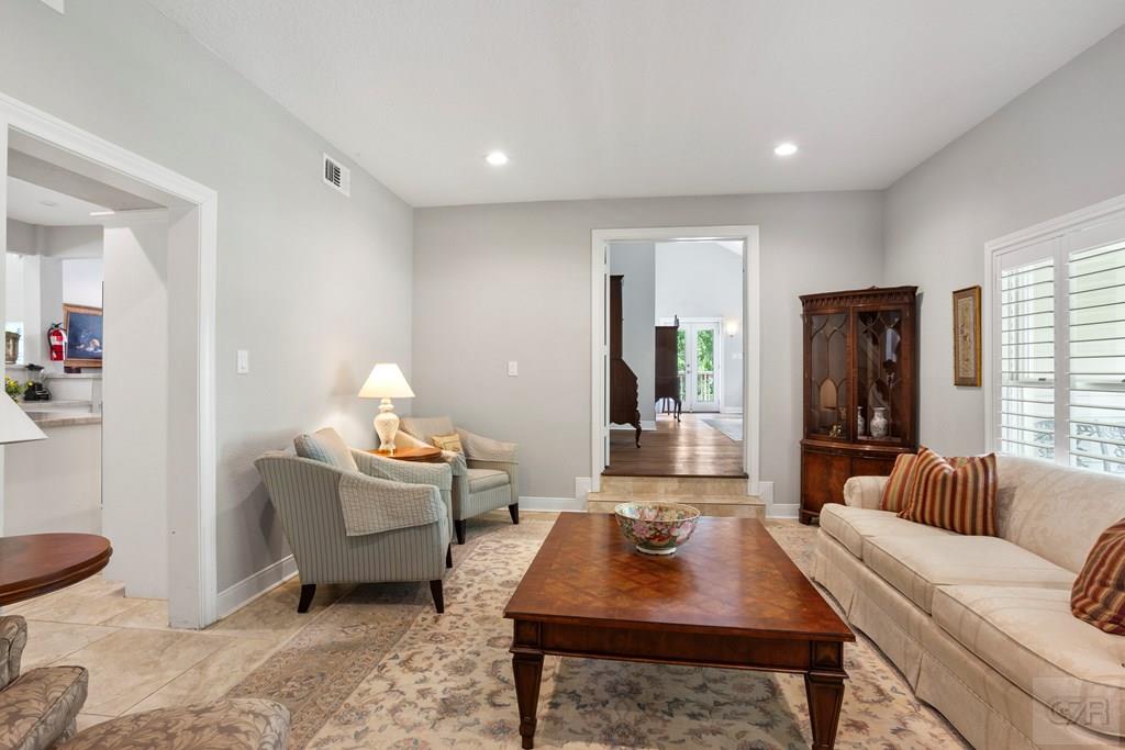 14009 West Hughes Road Dickinson, TX 77539 - Photo 19 of 54 a living room with furniture a table and a large window