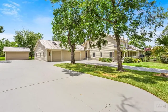 a view of house with outdoor space and tree s