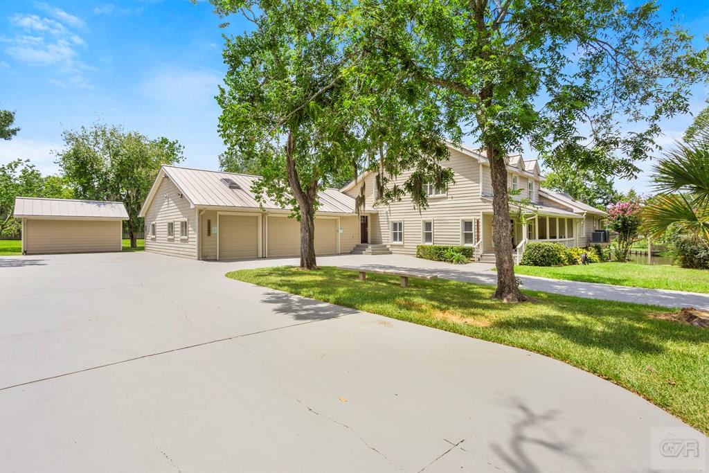 14009 West Hughes Road Dickinson, TX 77539 - Photo 2 of 54 a view of house with outdoor space and tree s