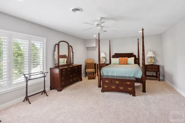 a bedroom with a bed and dresser