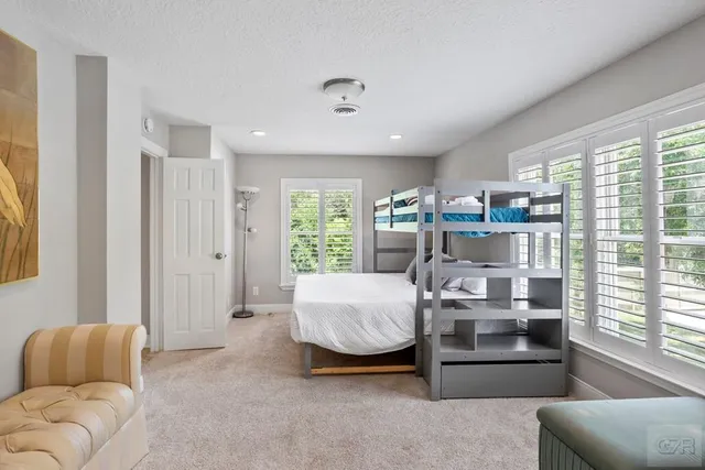 a spacious bathroom with a double vanity sink a mirror and a bathtub