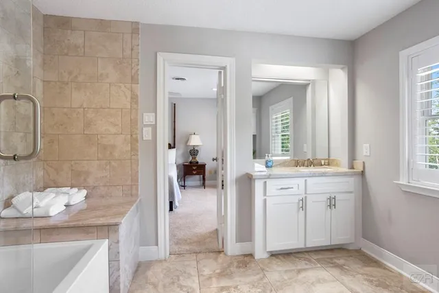 a bathroom with a tub shower and sink