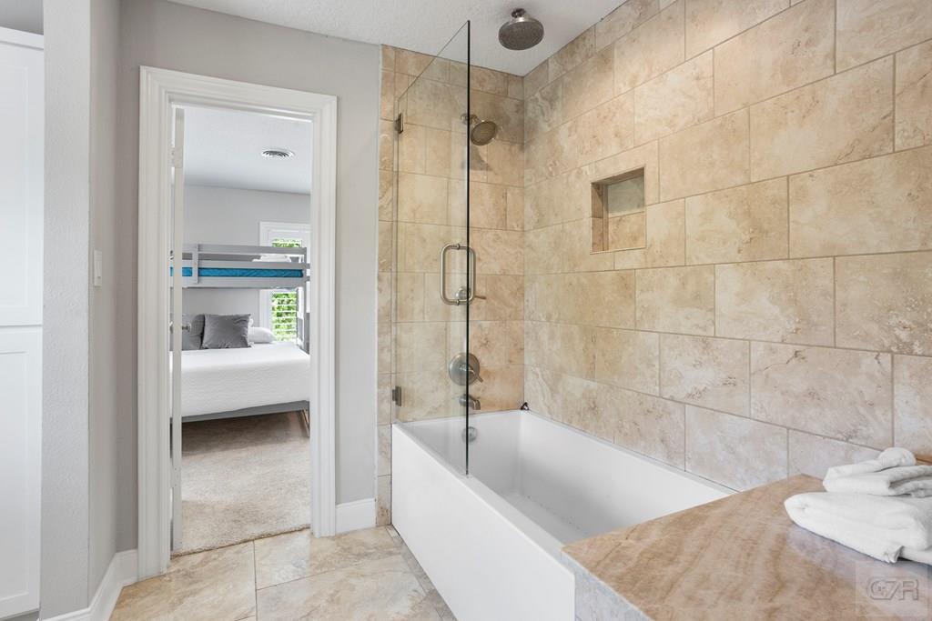 14009 West Hughes Road Dickinson, TX 77539 - Photo 29 of 54 a bathroom with a tub shower and sink