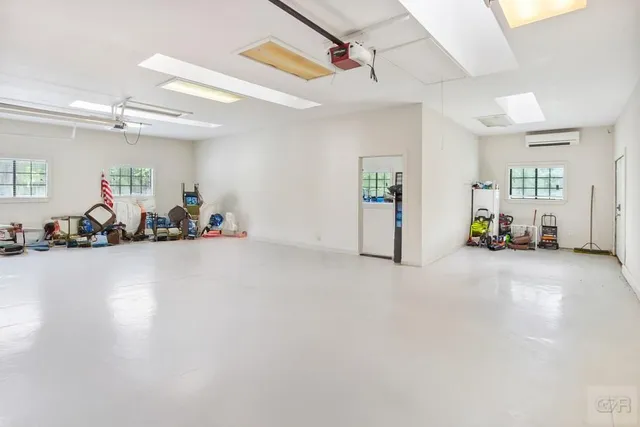 a living room with furniture a table and chairs