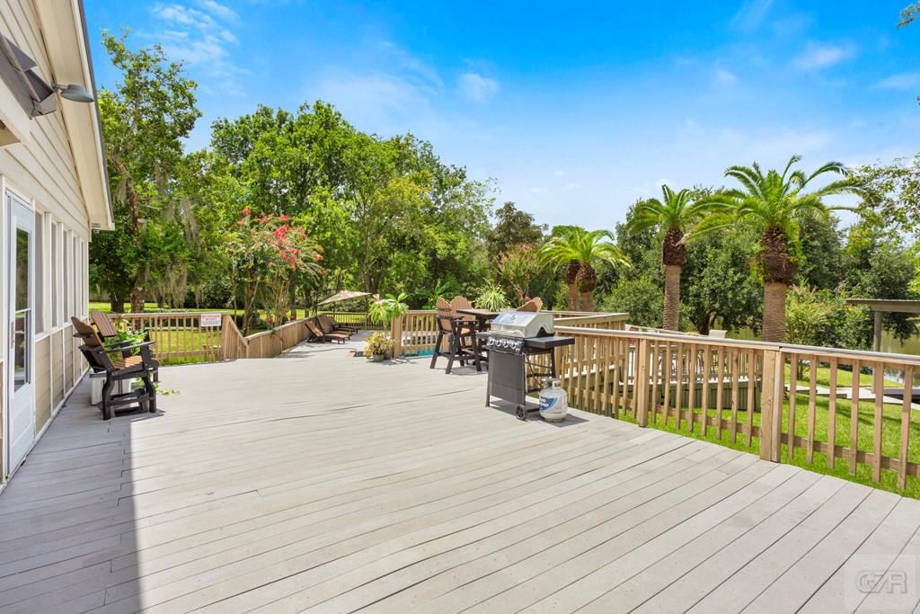 14009 West Hughes Road Dickinson, TX 77539 - Photo 34 of 54 a view of a deck with wooden floor and fence with a bench