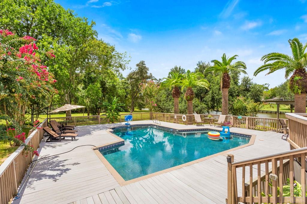 14009 West Hughes Road Dickinson, TX 77539 - Photo 36 of 54 a view of a swimming pool with a patio