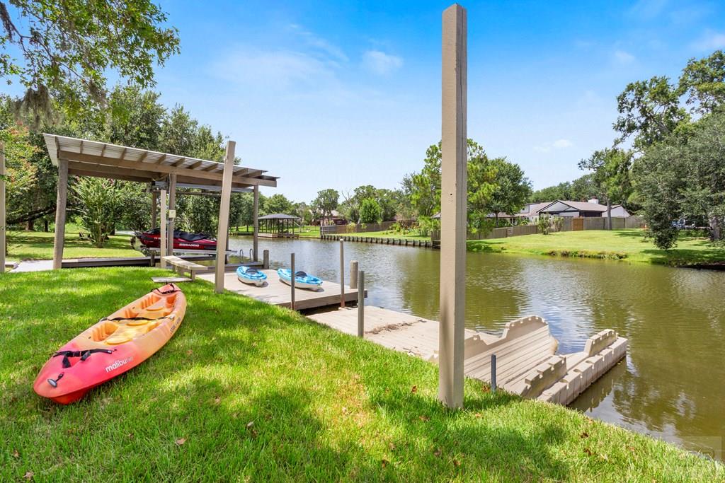 14009 West Hughes Road Dickinson, TX 77539 - Photo 40 of 54 a view of a lake with a table and chairs