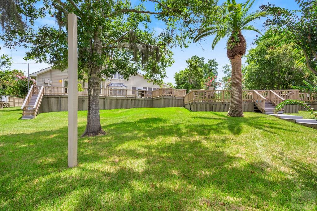 14009 West Hughes Road Dickinson, TX 77539 - Photo 45 of 54 a view of a backyard with a small cabin