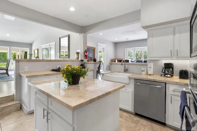 a kitchen with a sink refrigerator and cabinets