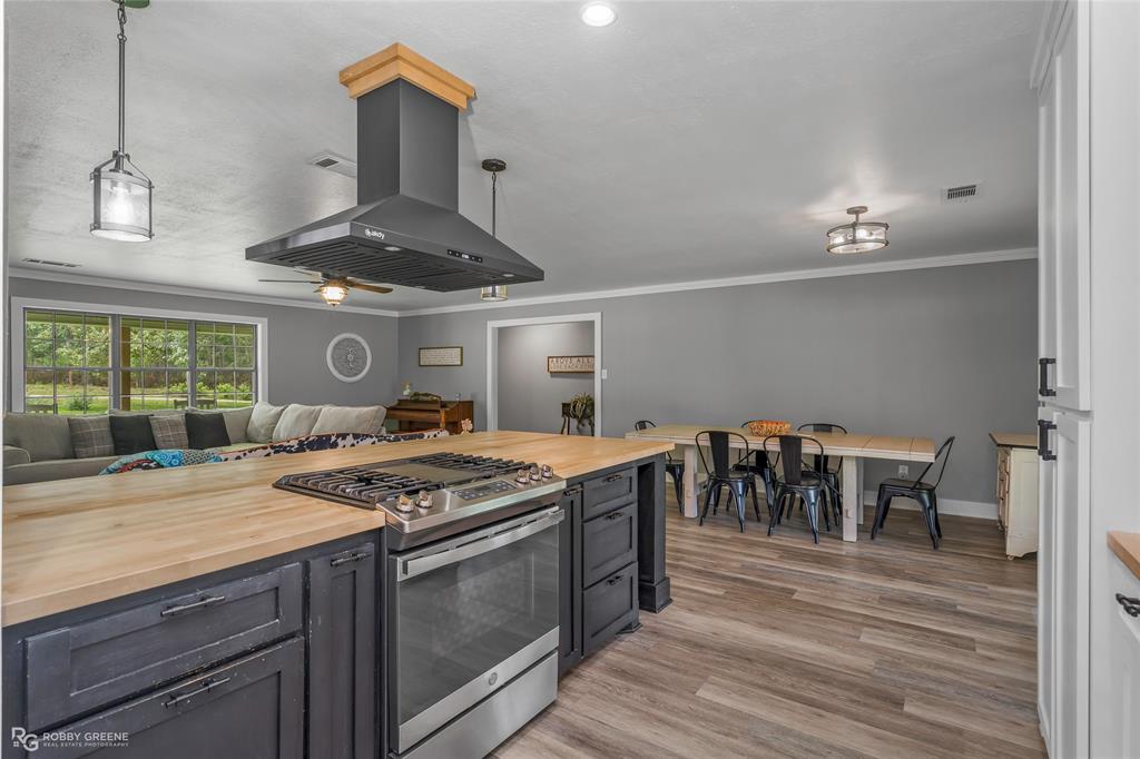 1426 Caney Lake Road Minden, LA 71055 - Photo 11 of 36 Open-concept living space featuring a central kitchen island with wood-finish countertop and built-in stainless steel range