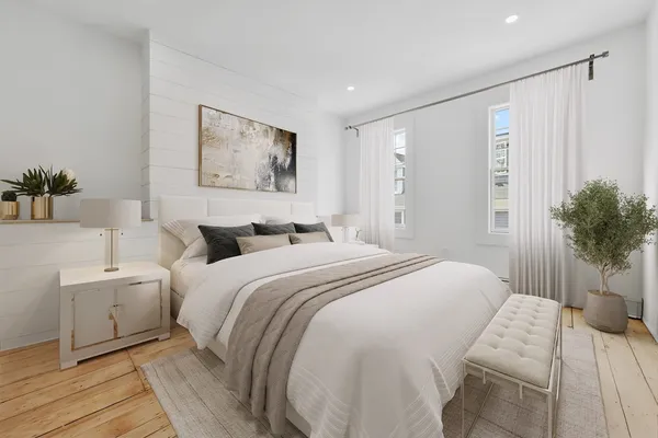 a spacious bedroom with a bed and a couch