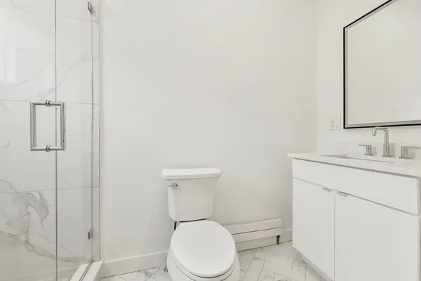 a bathroom with a toilet sink and shower