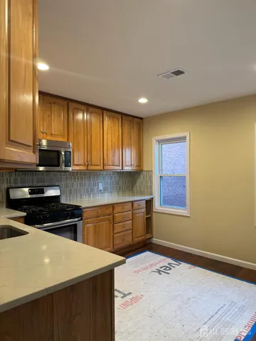 a kitchen with a stove a sink and a microwave