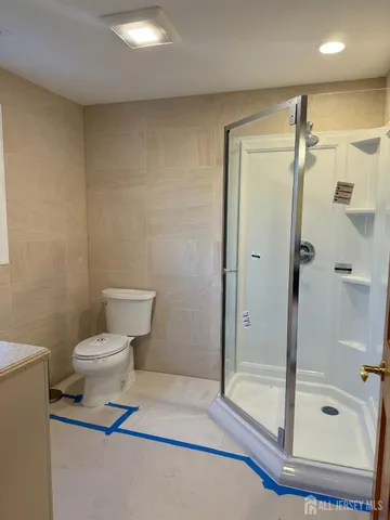 a bathroom with a shower and a toilet
