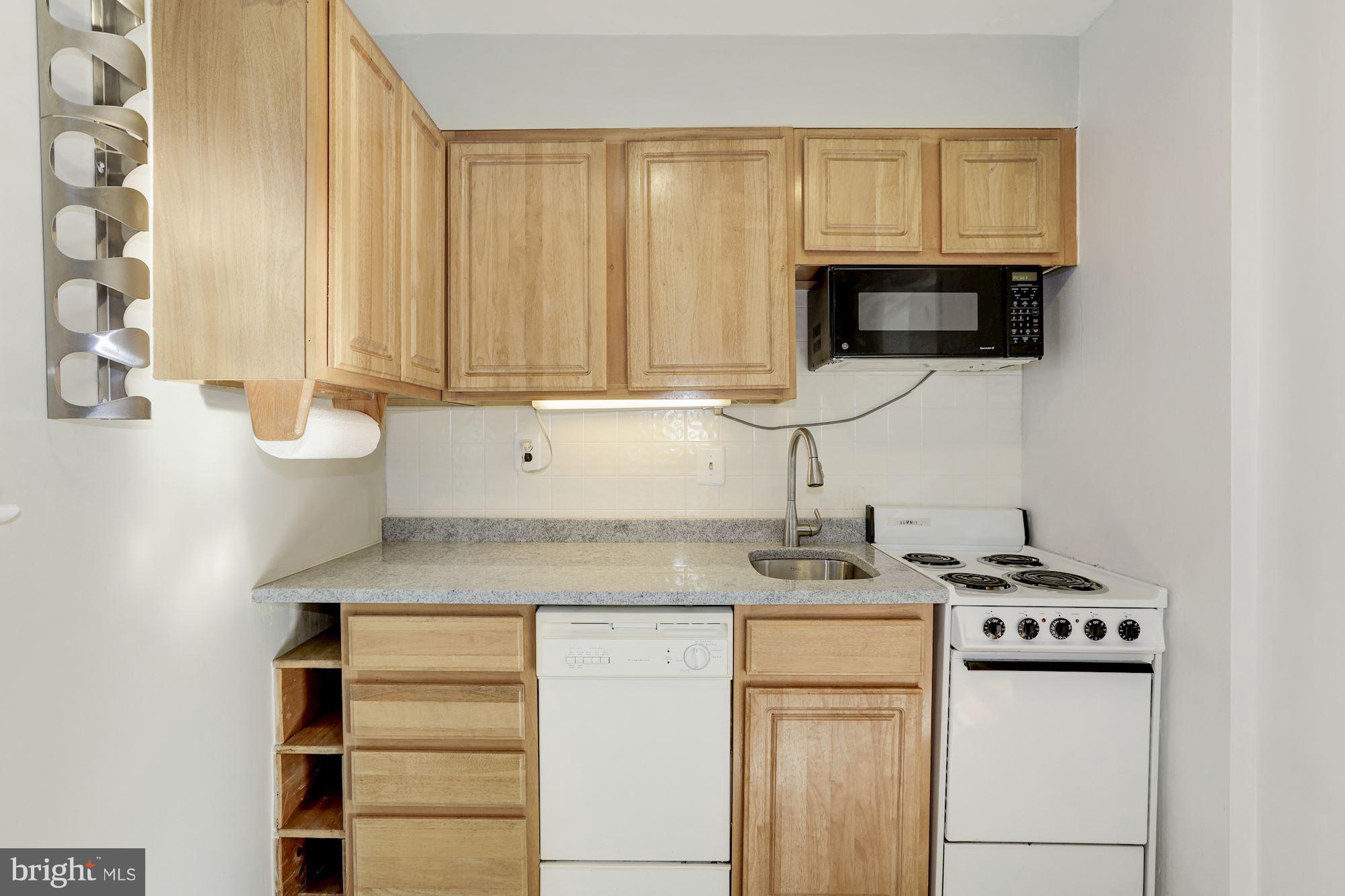 5018 Laguna Road College Park, MD 20740 - Photo 11 of 30 a kitchen with stainless steel appliances a stove a sink and a microwave