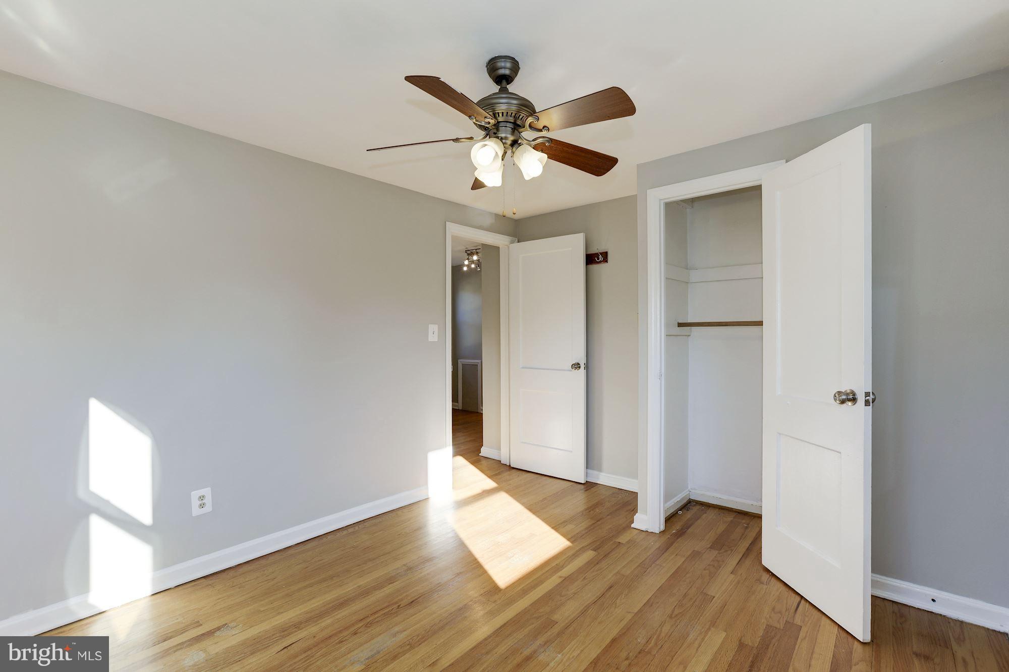5018 Laguna Road College Park, MD 20740 - Photo 17 of 30 a view of an empty room with wooden floor and a ceiling fan