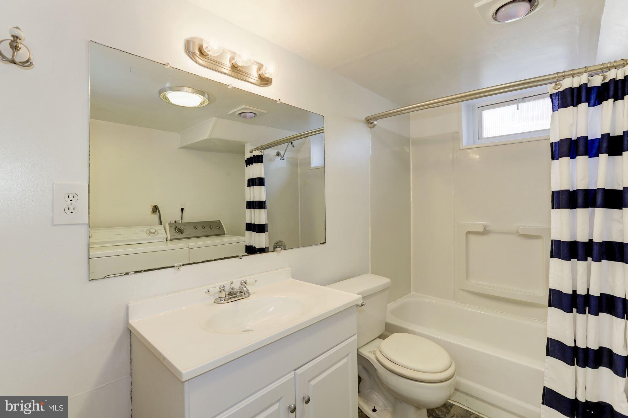 5018 Laguna Road College Park, MD 20740 - Photo 23 of 30 a bathroom with a sink a toilet a shower and a mirror