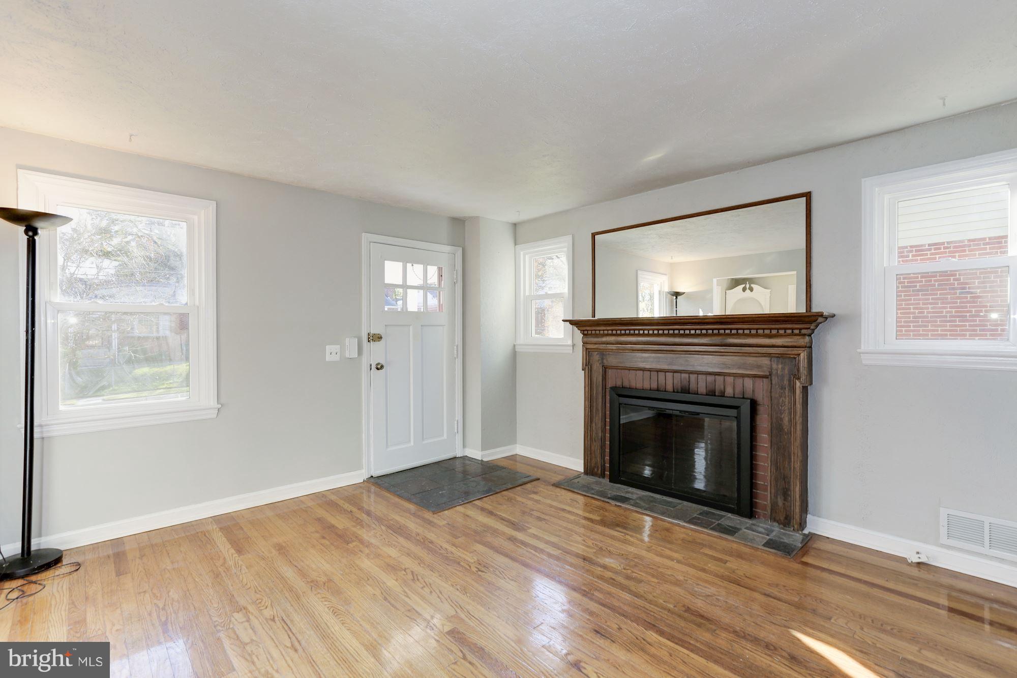 5018 Laguna Road College Park, MD 20740 - Photo 6 of 30 a view of empty room with wooden floor and fireplace